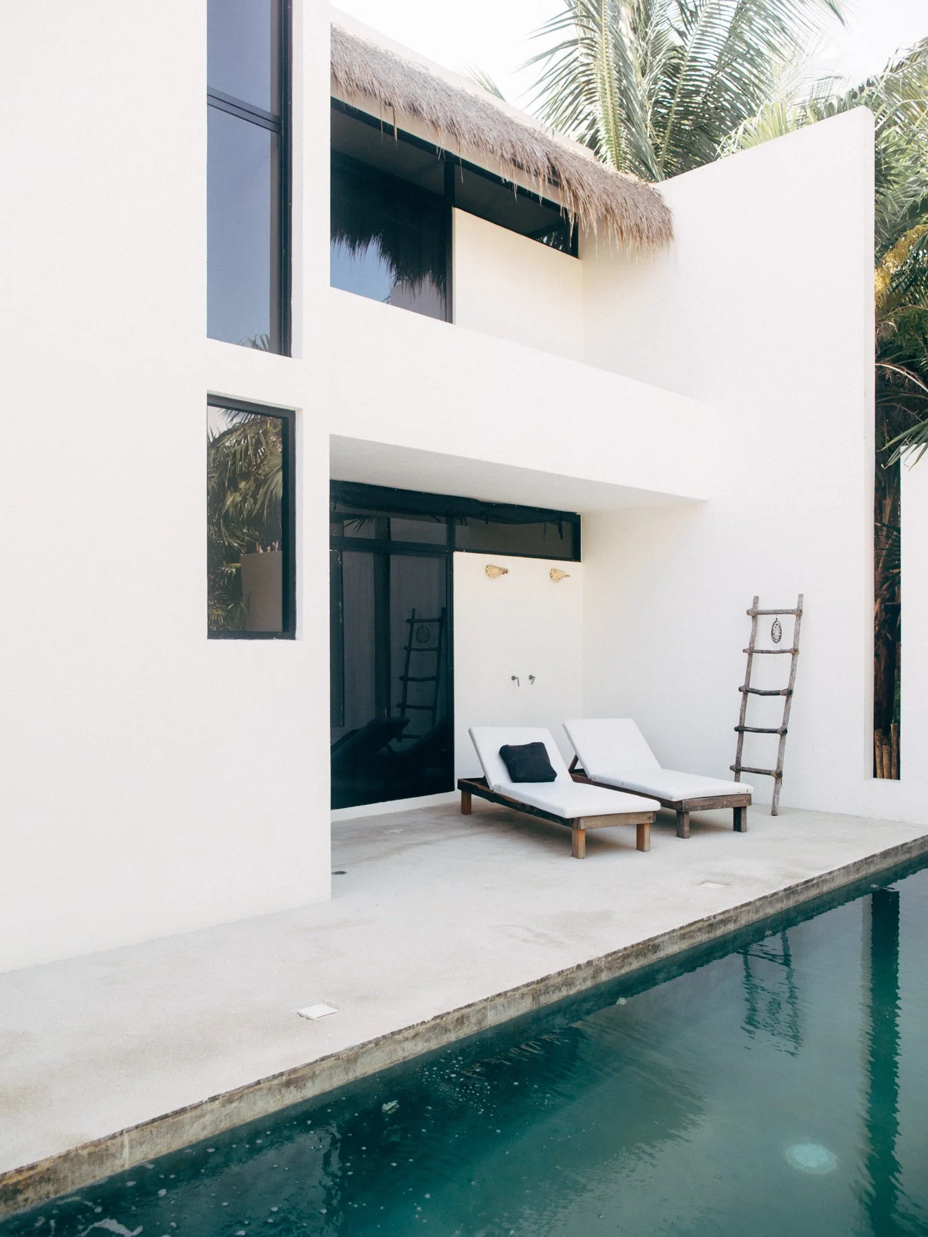 A narrow pool beside a white courtyard